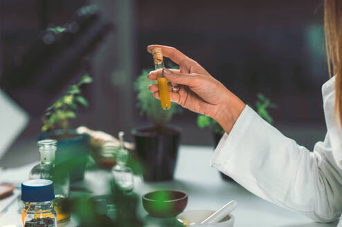 Naturopathic practitioner holds vial of a natural medicine concoction in Lehigh Valley.