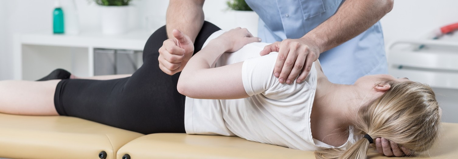 Female patient receives chiropractic adjustment by a medical professional in Lehigh Valley.