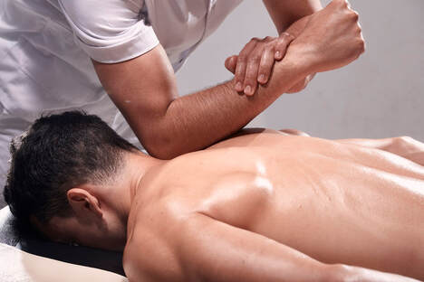 Young man receives deep tissue massage by body working practitioner in Lehigh Valley.
